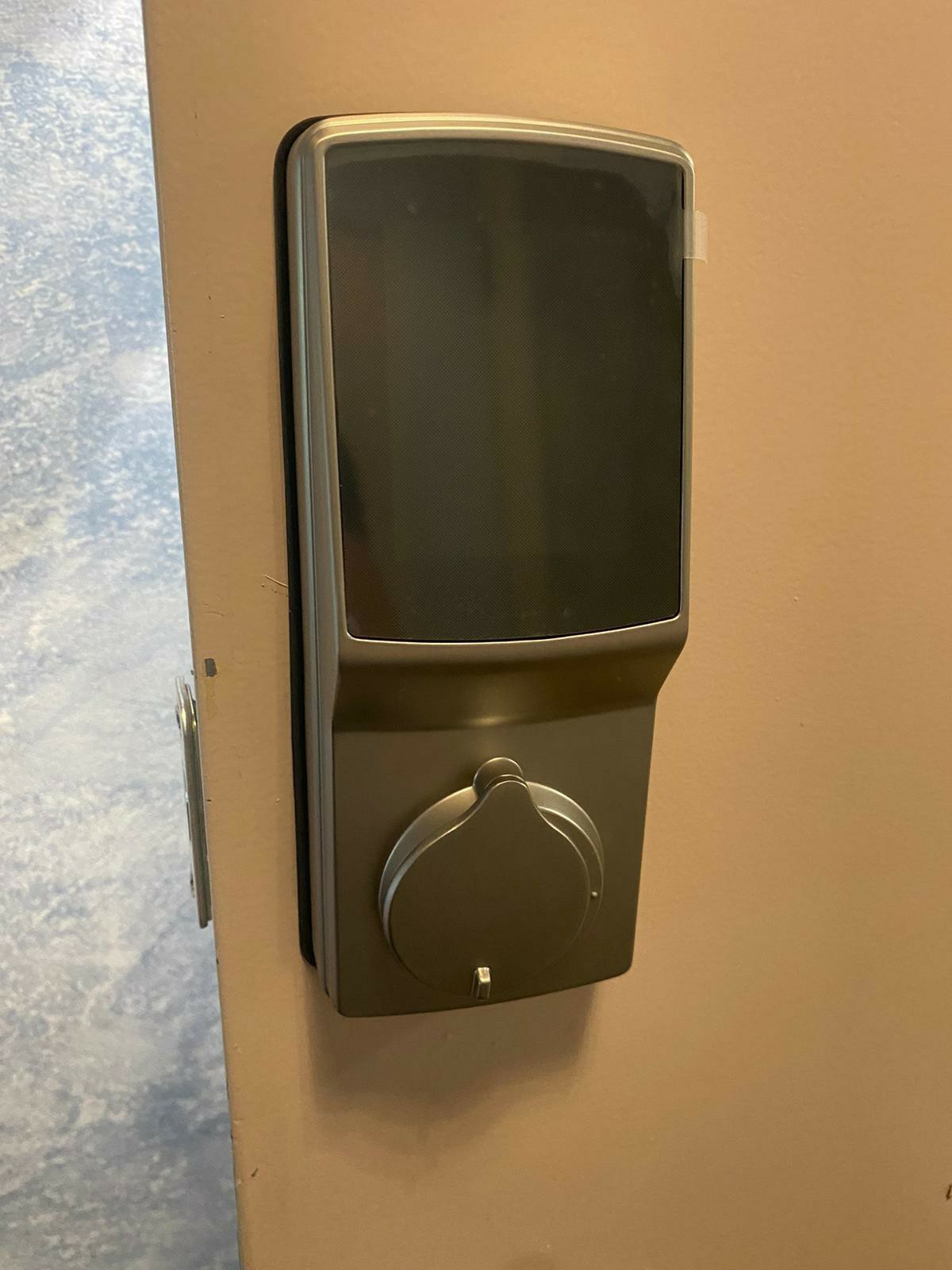 Touchscreen smart lock installed on a residential entry door