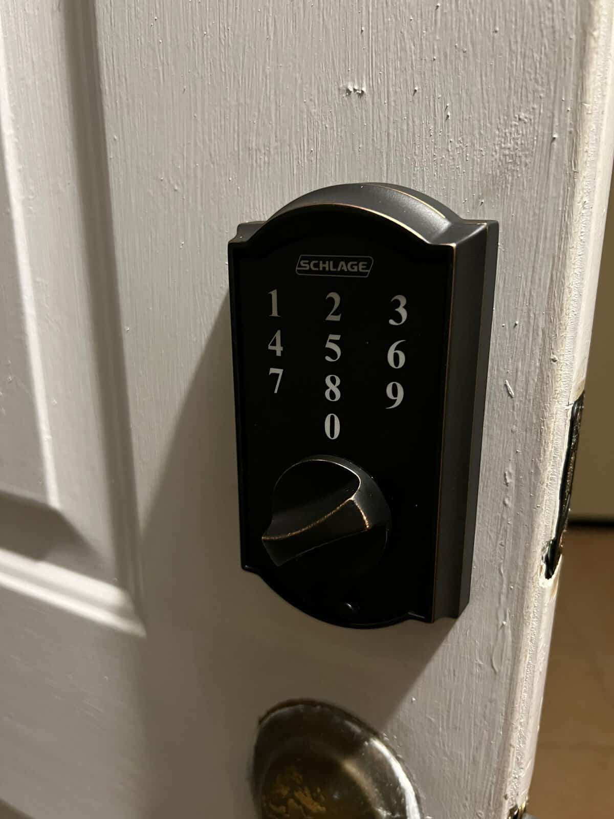 Digital keypad smart lock with backlit keys on a front door