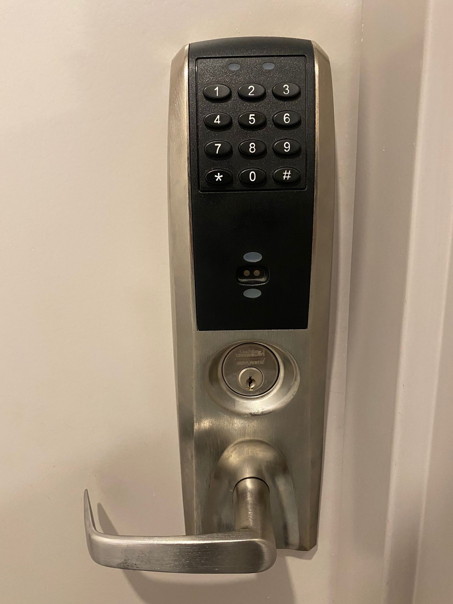 Electronic smart lock with keypad and key override installed on a door